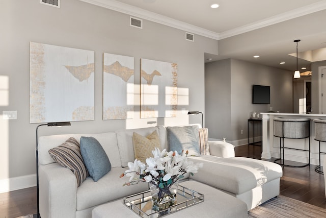 living room with hardwood / wood-style floors and crown molding