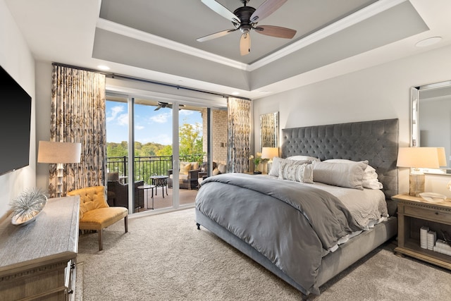 bedroom featuring carpet, access to exterior, ceiling fan, ornamental molding, and a tray ceiling