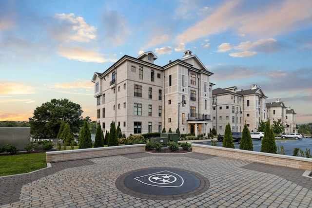 view of outdoor building at dusk