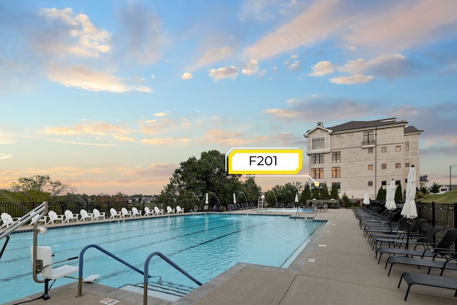 view of pool at dusk