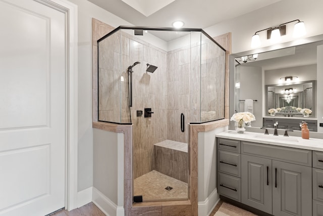 bathroom featuring an enclosed shower and vanity