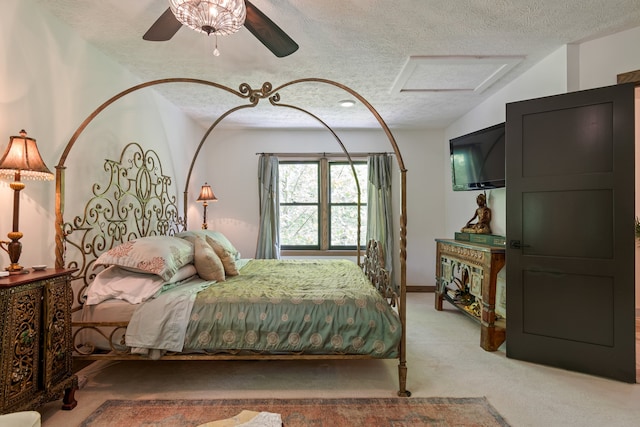 carpeted bedroom featuring a textured ceiling, vaulted ceiling, and ceiling fan