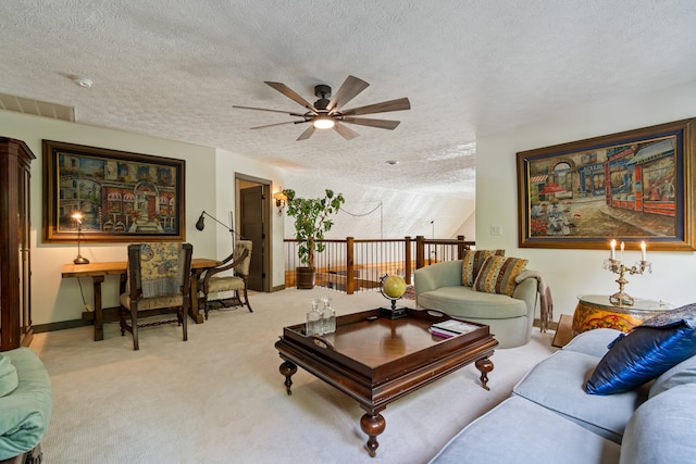 living room featuring a textured ceiling, light carpet, and ceiling fan