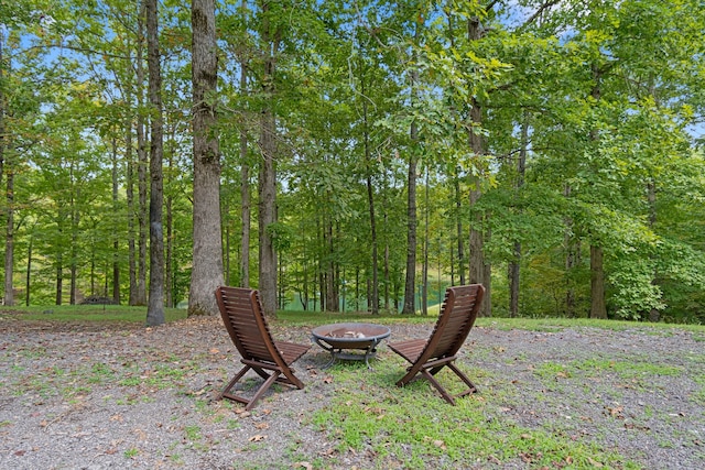 view of yard featuring an outdoor fire pit