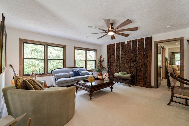 carpeted living room with a textured ceiling and ceiling fan