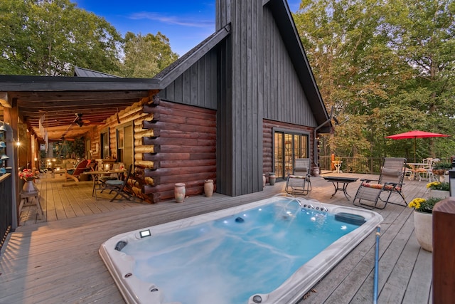 wooden deck featuring ceiling fan