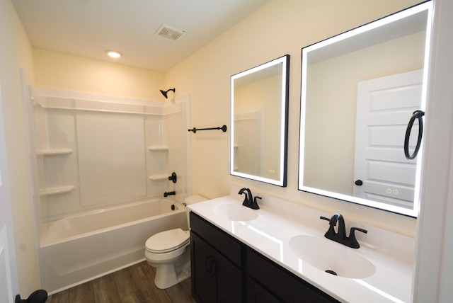 full bathroom with visible vents, a sink, toilet, and wood finished floors