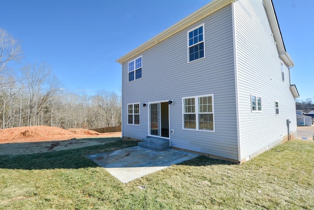 back of house featuring entry steps, a yard, crawl space, and a patio area