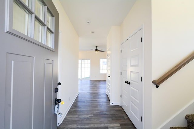 hall featuring stairs, dark wood finished floors, and baseboards