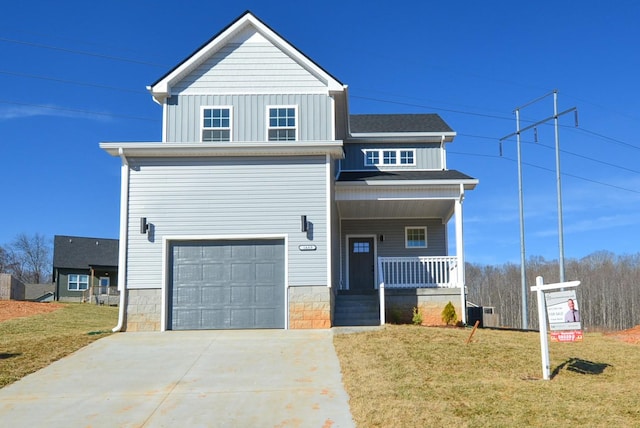 view of front facade with an attached garage, covered porch, a front lawn, and board and batten siding