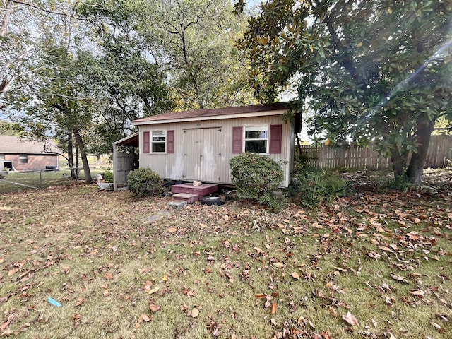 view of outbuilding with a lawn