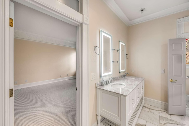 bathroom featuring a sink, marble finish floor, double vanity, baseboards, and ornamental molding