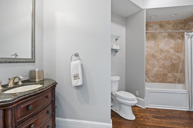 full bathroom with shower / bath combination with curtain, hardwood / wood-style flooring, vanity, and toilet