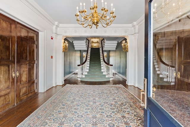 interior space featuring an inviting chandelier, crown molding, and dark hardwood / wood-style floors