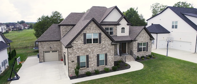 view of front of property with a front yard and a garage