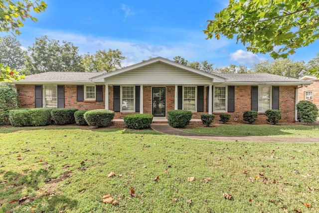 single story home featuring a front lawn