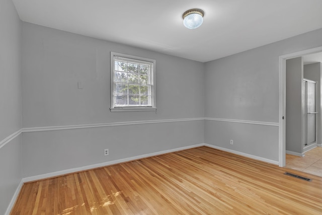 spare room with wood-type flooring