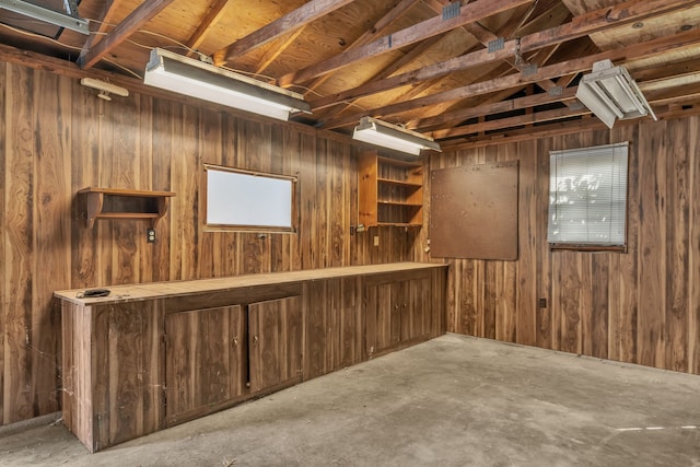 basement featuring wood walls