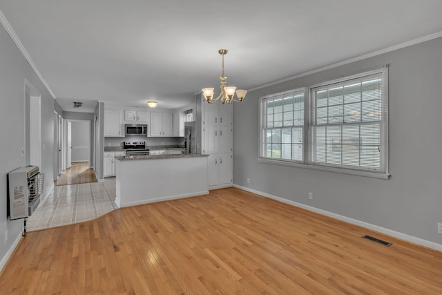 interior space with ornamental molding, heating unit, and light hardwood / wood-style floors