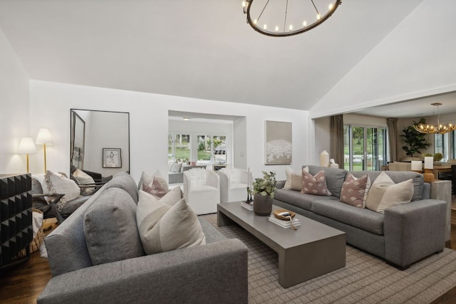 living room featuring a notable chandelier, high vaulted ceiling, plenty of natural light, and hardwood / wood-style floors