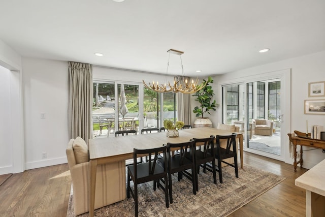 dining area featuring hardwood / wood-style floors and a chandelier