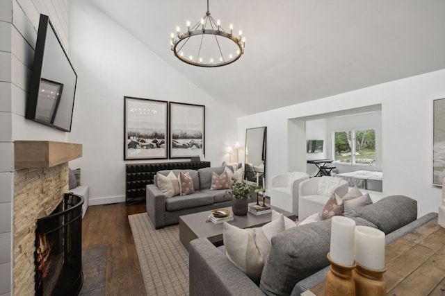 living room with a fireplace, dark hardwood / wood-style floors, high vaulted ceiling, and a notable chandelier