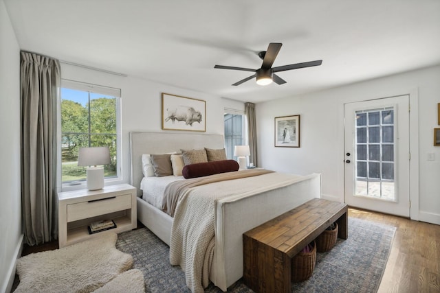 bedroom with wood-type flooring, ceiling fan, and access to exterior