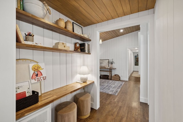 mudroom featuring wood ceiling, wood walls, and dark hardwood / wood-style flooring