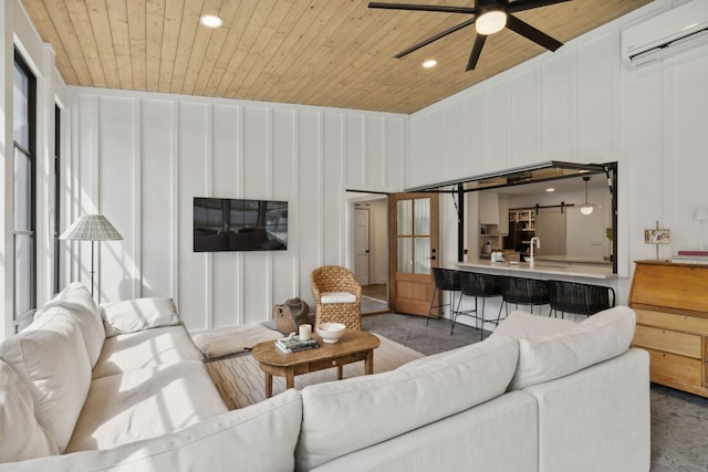 living room featuring ceiling fan, wood ceiling, and sink