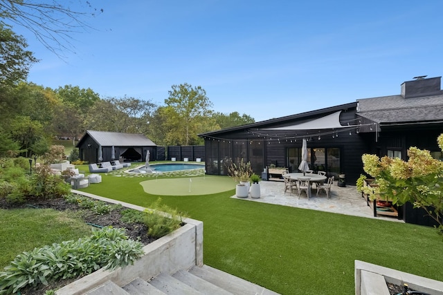 view of yard with a fenced in pool and a patio area