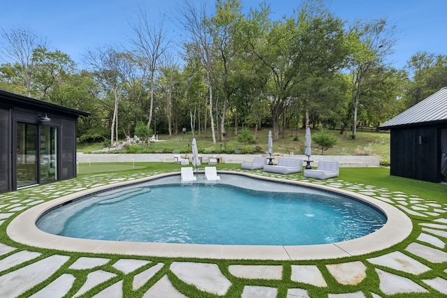 view of pool with a yard