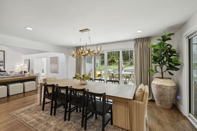 dining room with dark hardwood / wood-style flooring and a chandelier