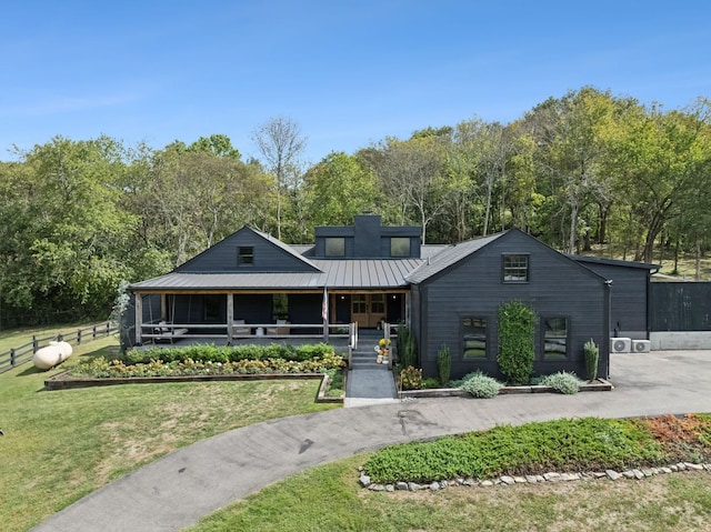 view of front facade with covered porch and a front yard