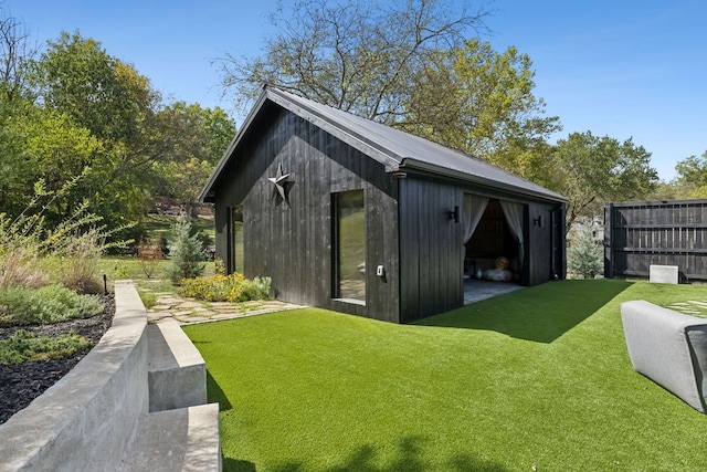 view of outdoor structure featuring a lawn