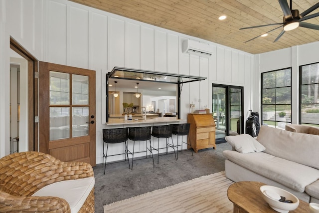 living room featuring wood ceiling, a towering ceiling, an AC wall unit, and ceiling fan