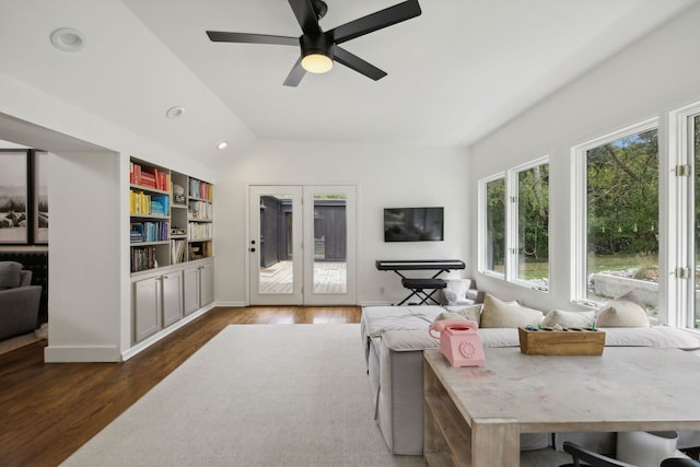 living room with dark wood-type flooring, ceiling fan, and french doors