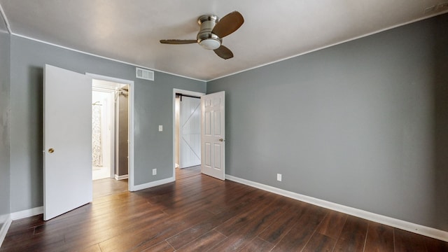 unfurnished bedroom featuring ceiling fan and dark hardwood / wood-style flooring