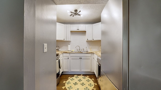 kitchen featuring white cabinets, a textured ceiling, sink, and stainless steel appliances