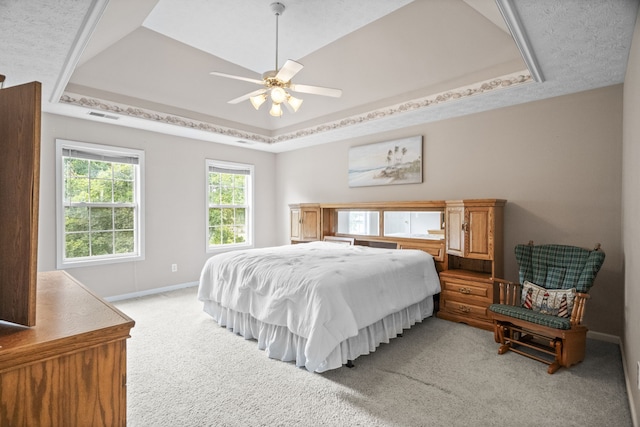 bedroom featuring a tray ceiling, ceiling fan, and light colored carpet