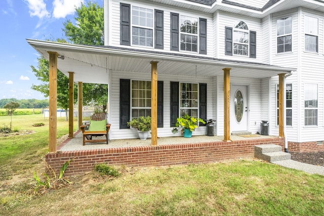 view of front of house featuring a porch and a front lawn