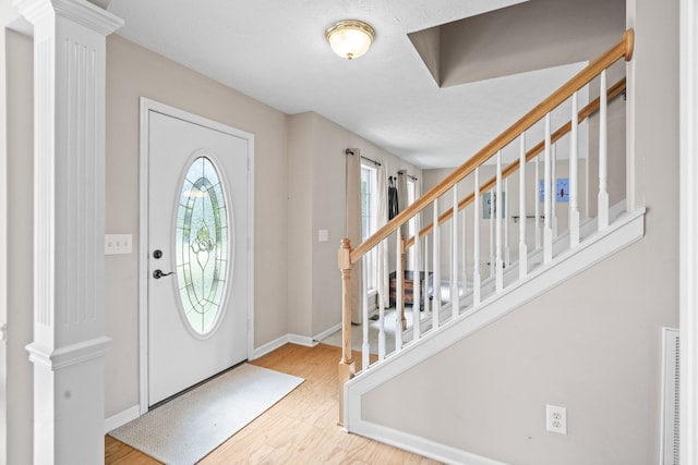 foyer with wood-type flooring