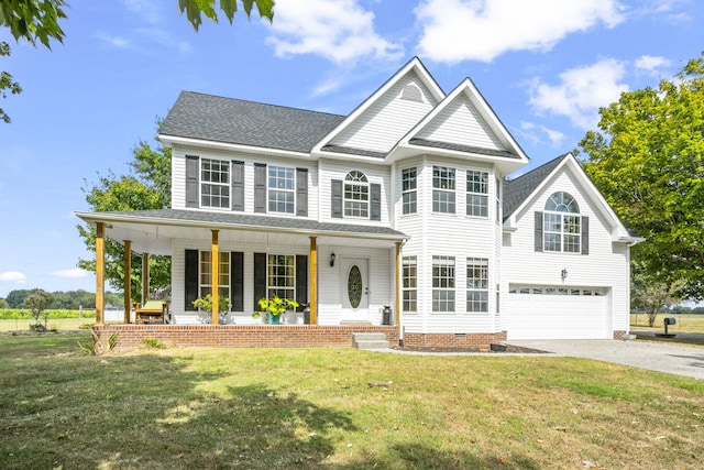 view of front of property featuring a porch, a garage, and a front yard