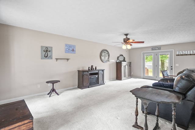 living room featuring ceiling fan and light colored carpet