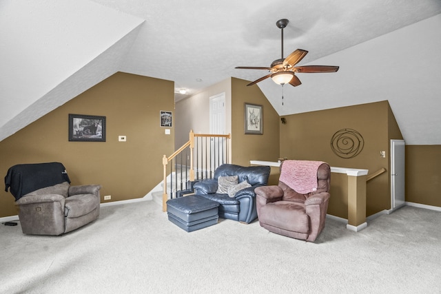 living room featuring ceiling fan, carpet floors, and vaulted ceiling