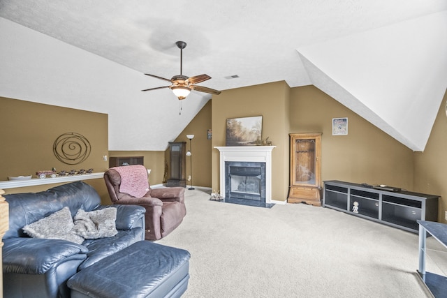 carpeted living room featuring lofted ceiling, a tiled fireplace, and ceiling fan