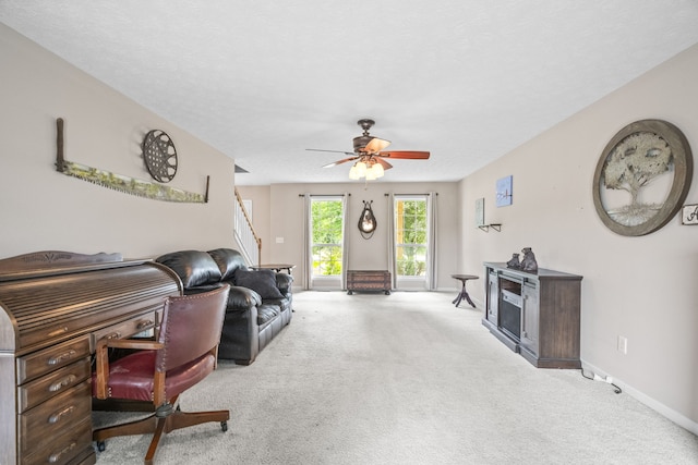 carpeted living room with ceiling fan