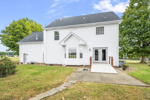 back of house featuring a lawn and a patio