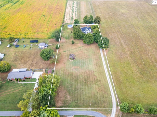 birds eye view of property with a rural view