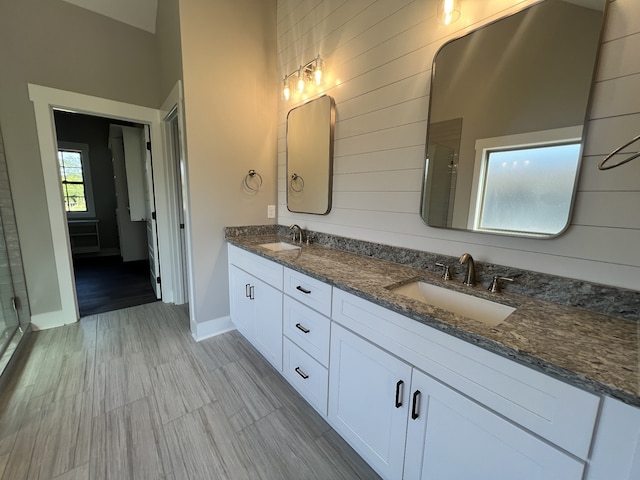 bathroom featuring hardwood / wood-style floors, an enclosed shower, and vanity