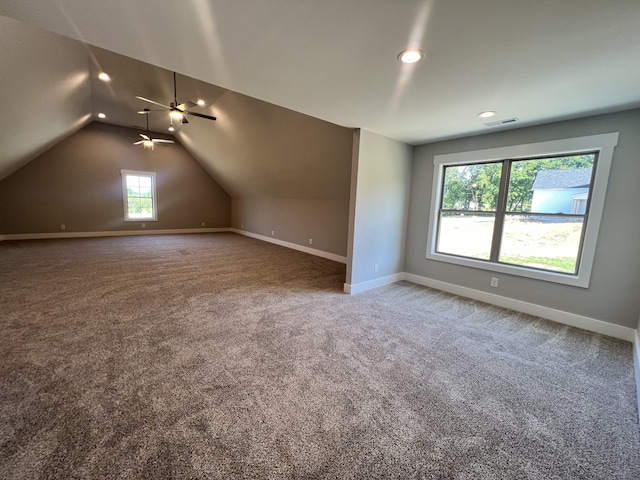 bonus room with carpet flooring and vaulted ceiling